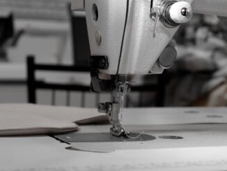 bernina - Closeup of an industrial sewing machine in a textile factory, focused on needle and fabric