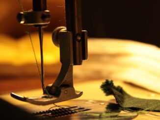 bernina - Detailed view of a sewing machine needle stitching fabric, highlighting craftsmanship.