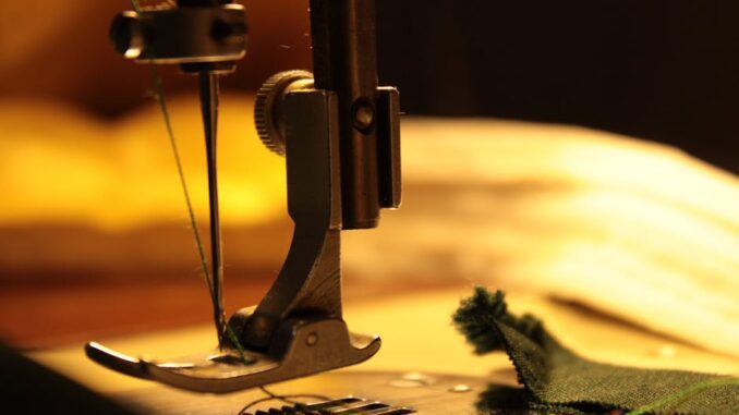bernina - Detailed view of a sewing machine needle stitching fabric, highlighting craftsmanship.