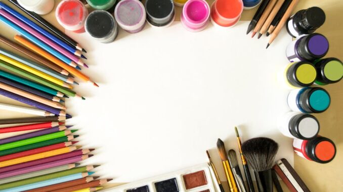 modulor berlin - Creative flat lay of colorful art supplies including paints, pencils, and brushes o